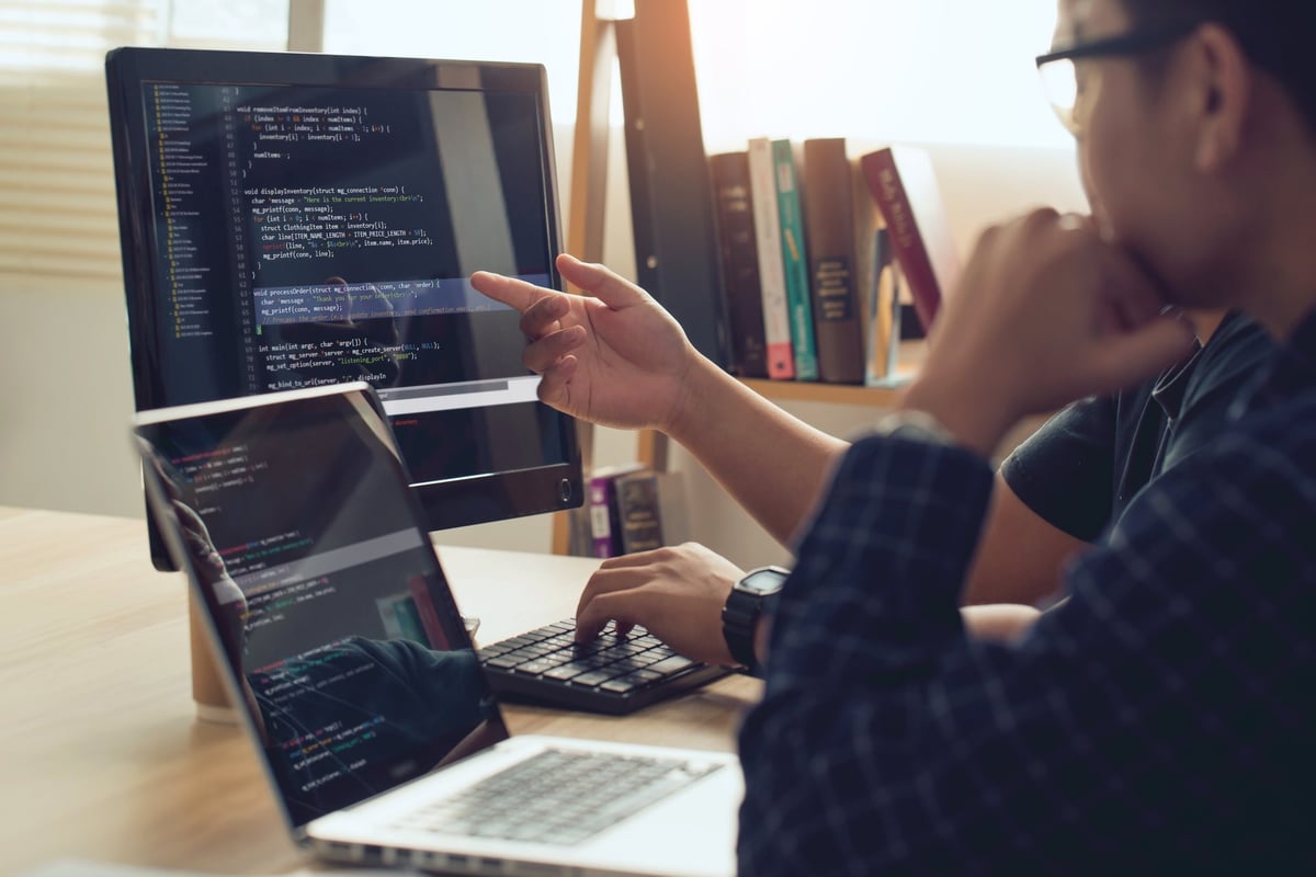 Web development team collaborating on code
